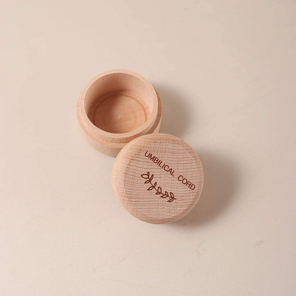 Natural beech wood keepsake box for baby's umbilical cord, with engraved leaf design.