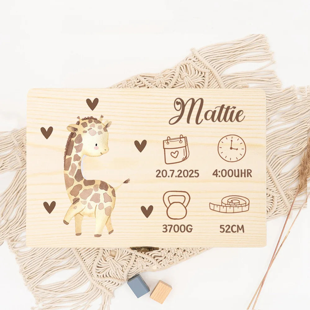 Personalized wooden baby memory box with a cute giraffe and birth details, on a macrame mat.