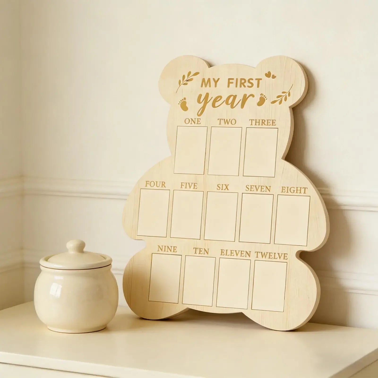 Wooden bear-shaped baby milestone board for "My First Year," with 12 monthly photo slots.
