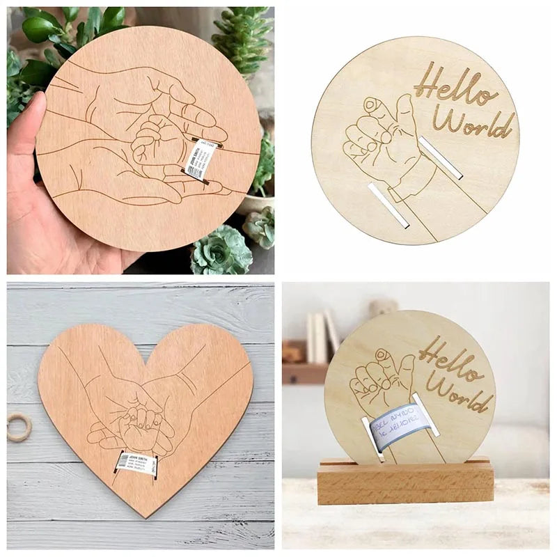 Wooden birth keepsake plaque with engraved hands holding a baby's wristband, "Hello World" text, and a stand.