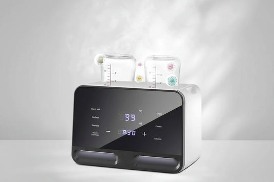 White digital baby bottle warmer and sterilizer with two bottles, a black touchscreen display, and steam.