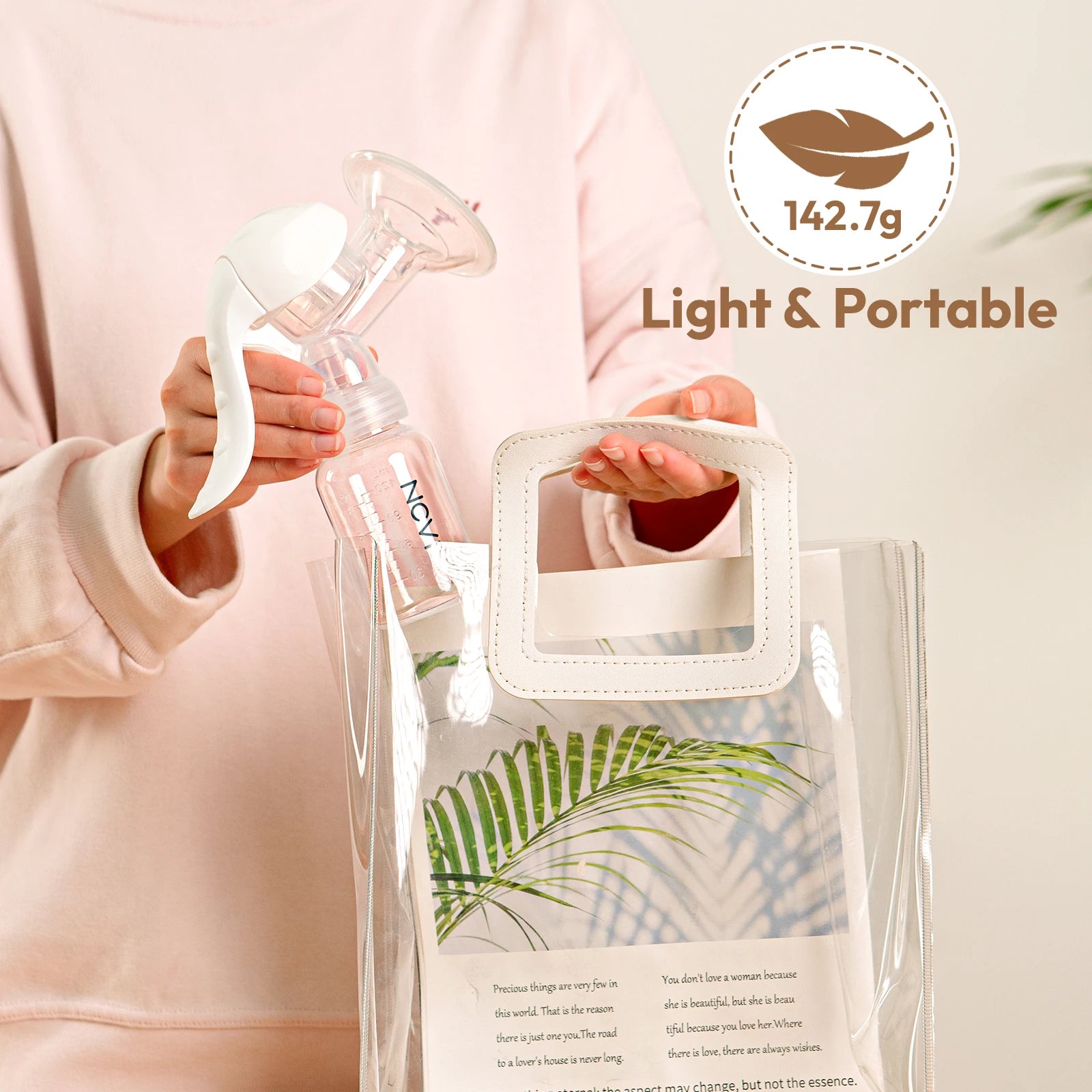 Woman holding a white manual silicone breast pump with a clear bottle, next to a clear tote bag.