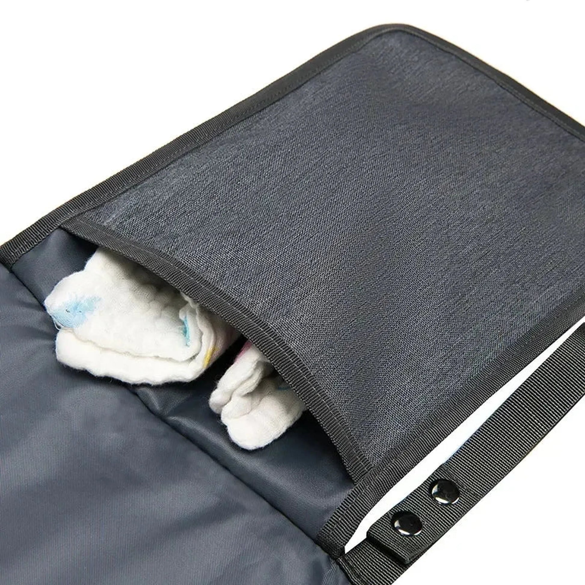 Dark gray portable waterproof baby changing pad with an open pocket holding white cloths.