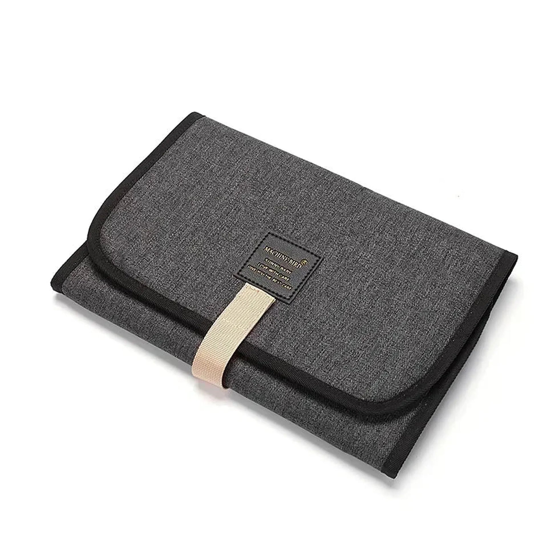 Foldable gray waterproof baby changing pad with black trim and beige strap.