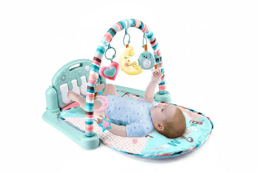 Baby activity mat with a teal piano, colorful arch, and hanging toys.