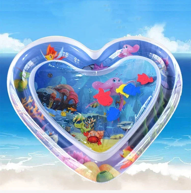 Heart-shaped inflatable water play mat with colorful floating sea creatures for baby tummy time.