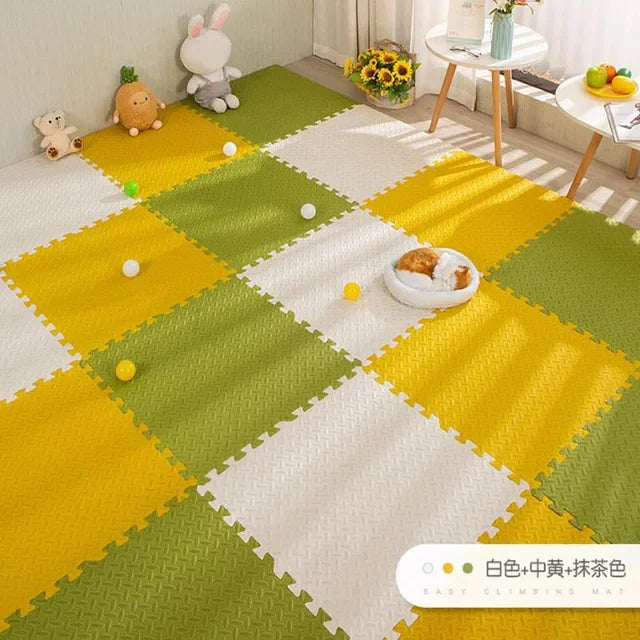 Foam puzzle play mat for baby, 16 pieces, in yellow, green, and white, with textured surface.