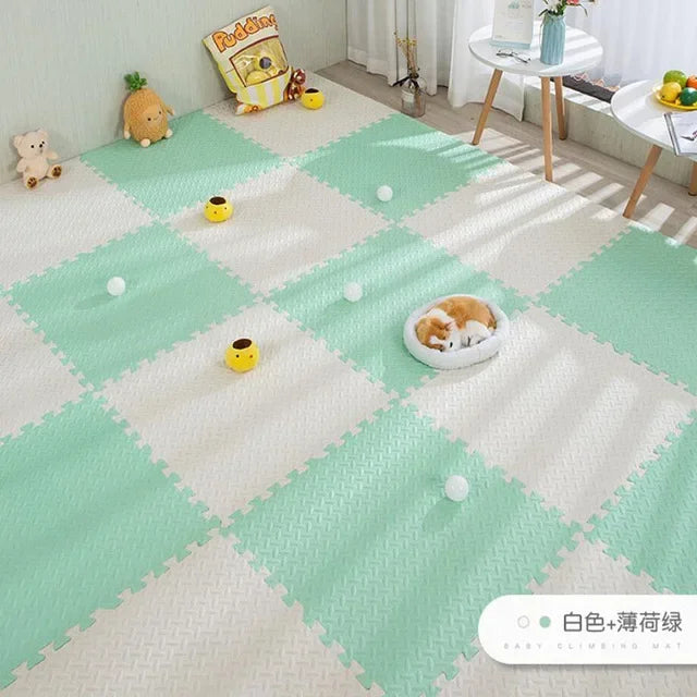 Mint green and white interlocking foam puzzle play mat for babies, with a textured surface.