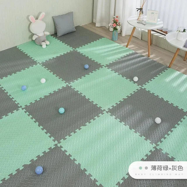 Mint green and gray interlocking EVA foam puzzle play mat for babies, 16 pieces, with textured surface.