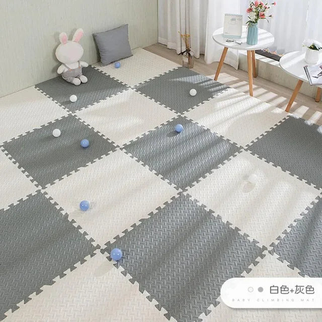 Gray and white interlocking EVA foam puzzle play mat for babies, featuring a textured, non-slip surface.