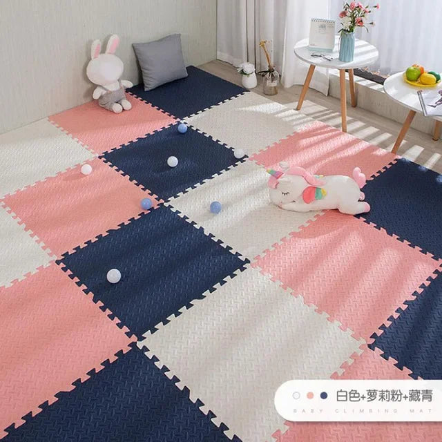 Pink, white, and navy blue EVA foam puzzle play mat for babies, with a textured surface.