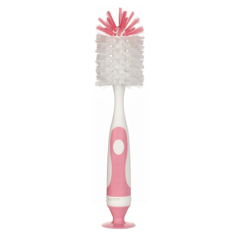 Pink and white dual-stage baby bottle cleaning brush with a vacuum base for hygienic storage.