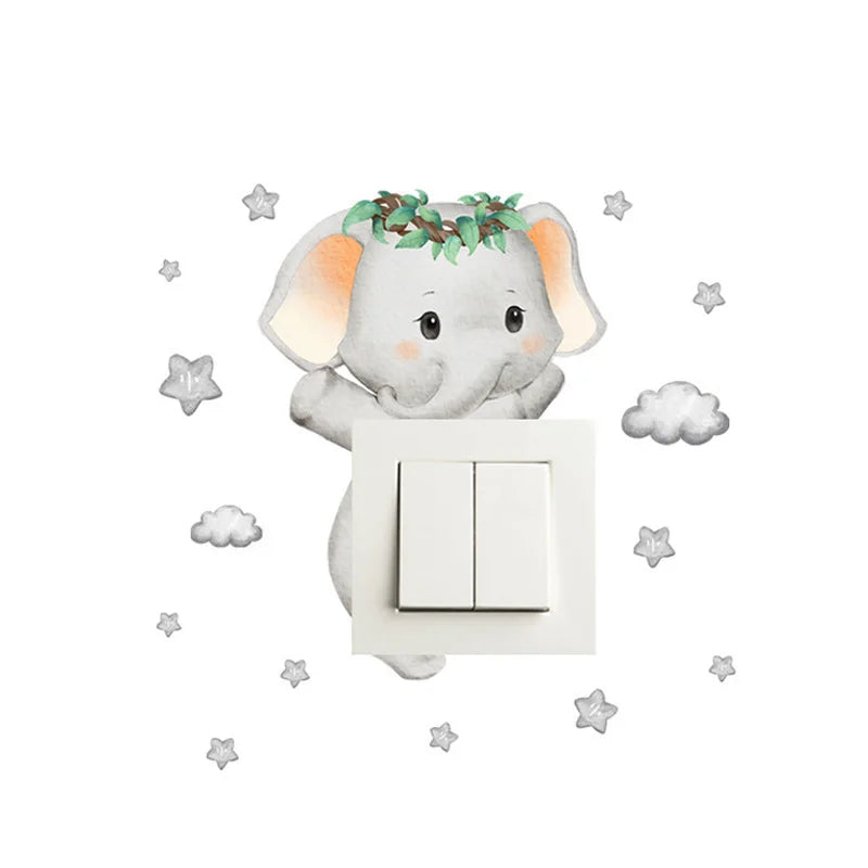 Cute baby elephant wall decal with green wreath, peeking over a white light switch, surrounded by grey stars and clouds.