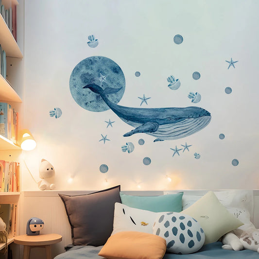 Watercolor whale and sea creature wall decals on a white wall in a child's bedroom.