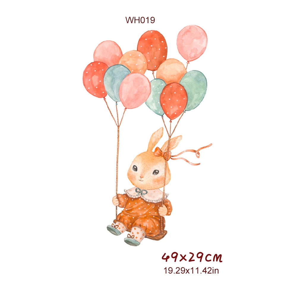 Watercolor bunny in a polka-dot dress on a swing, held by colorful balloons. PVC wall decal, 49x29cm.