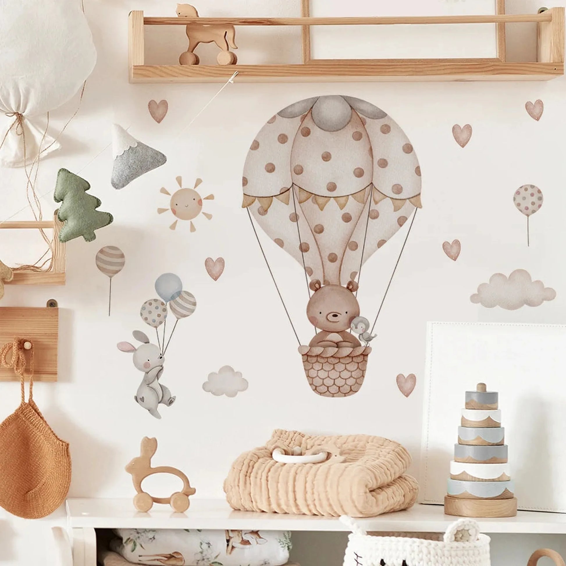 Nursery wall decals with a bear in a polka-dot hot air balloon, bunnies with balloons, hearts, and clouds.