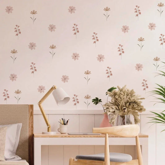Watercolor flower wall decals in pink and beige, decorating a child's room above a wooden desk.