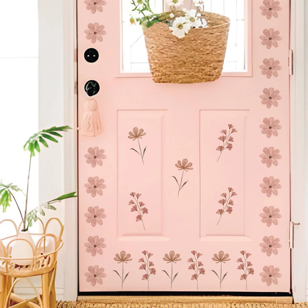 Pink door decorated with watercolor flower wall decals, featuring a basket and plant.