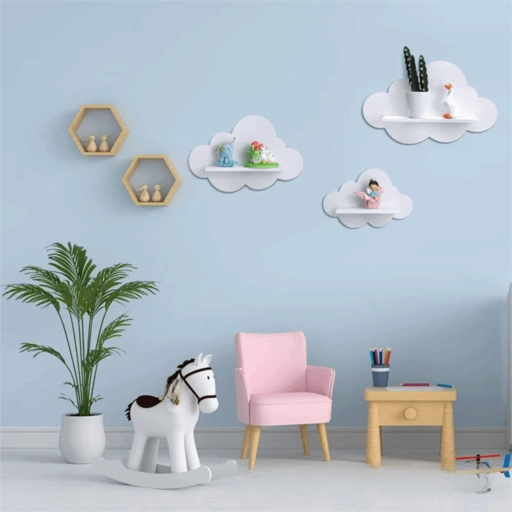White wooden cloud-shaped wall shelf for kids' room decor, displayed with toys on a blue wall.