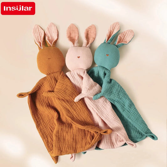 Three soft muslin cotton baby comforters in brown, pink, and teal, shaped like cute bunnies.