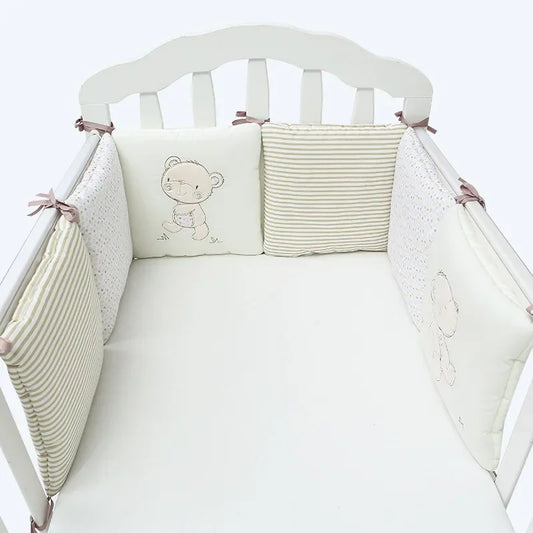Six-piece cotton crib bumper set with teddy bear embroidery and striped patterns, tied to a white crib.