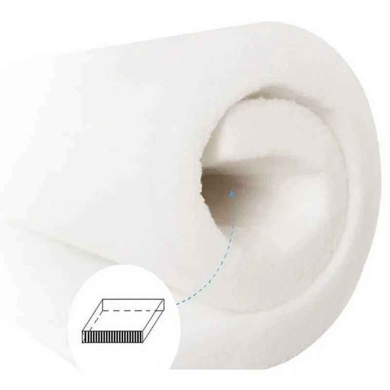 Rolled white cotton crib bumper with thick, breathable padding, showing internal structure.