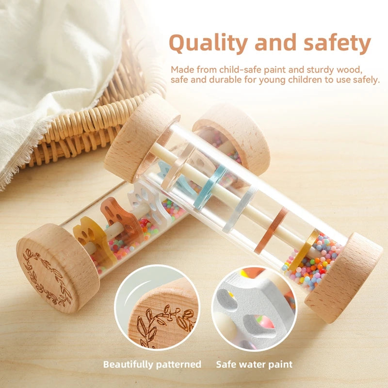 Clear Montessori rain stick toy with natural wood ends, colorful beads, and internal rainbow baffles.
