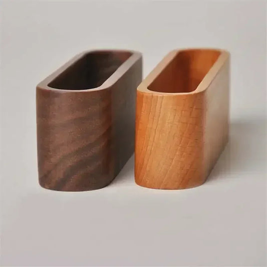 Two minimalist wooden desk organizers, one dark brown and one light natural wood, for business cards or notes.