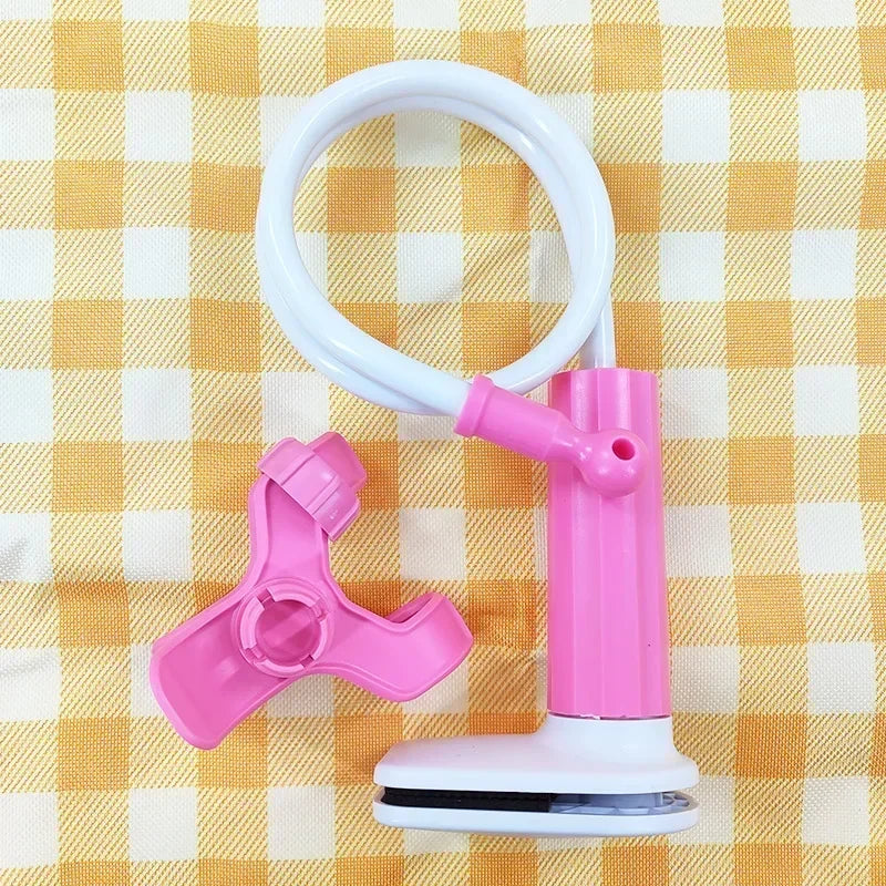 Pink and white flexible baby monitor holder with a long gooseneck arm and clamp, on a checkered background.