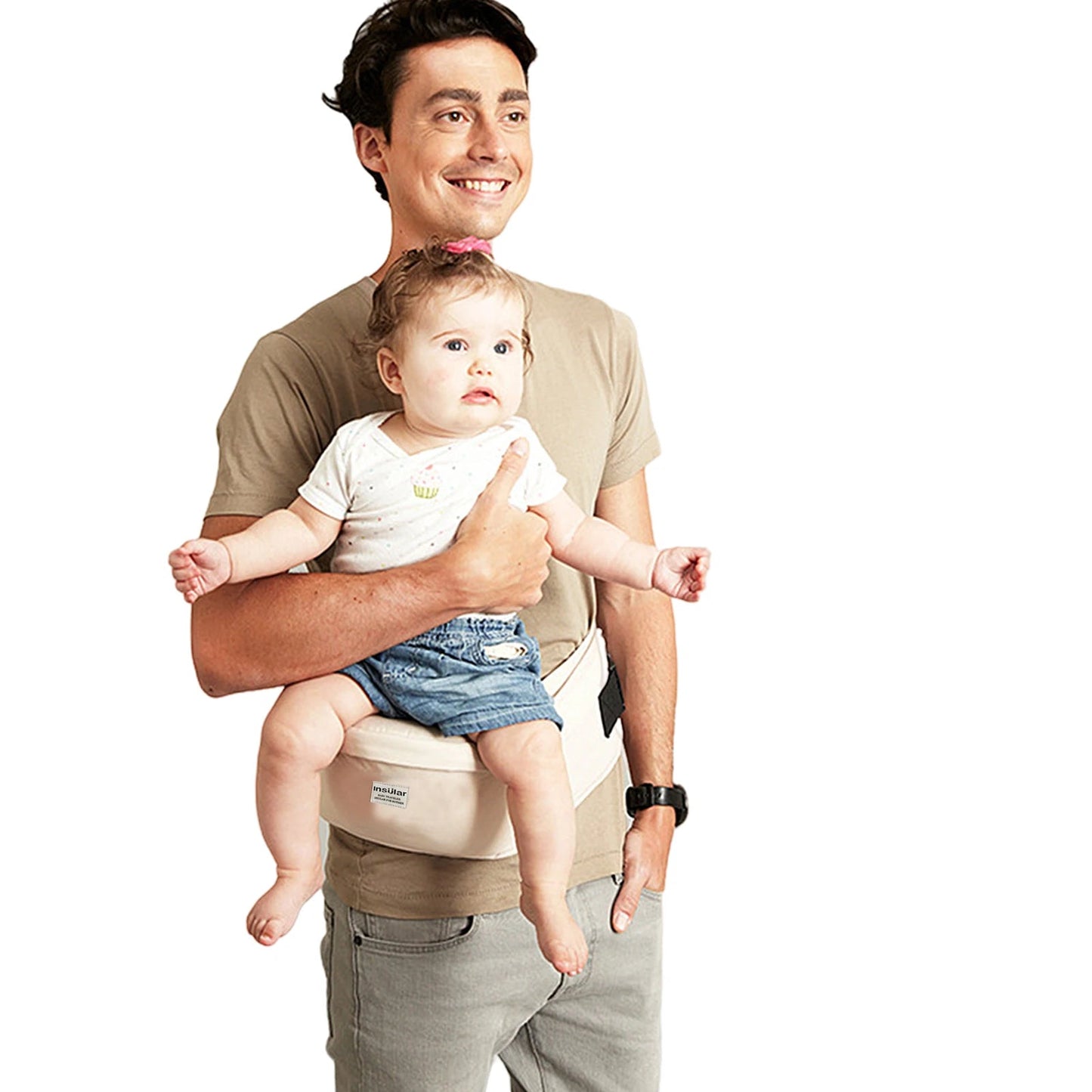 Smiling man carrying baby in a beige ergonomic hip seat carrier with adjustable straps.