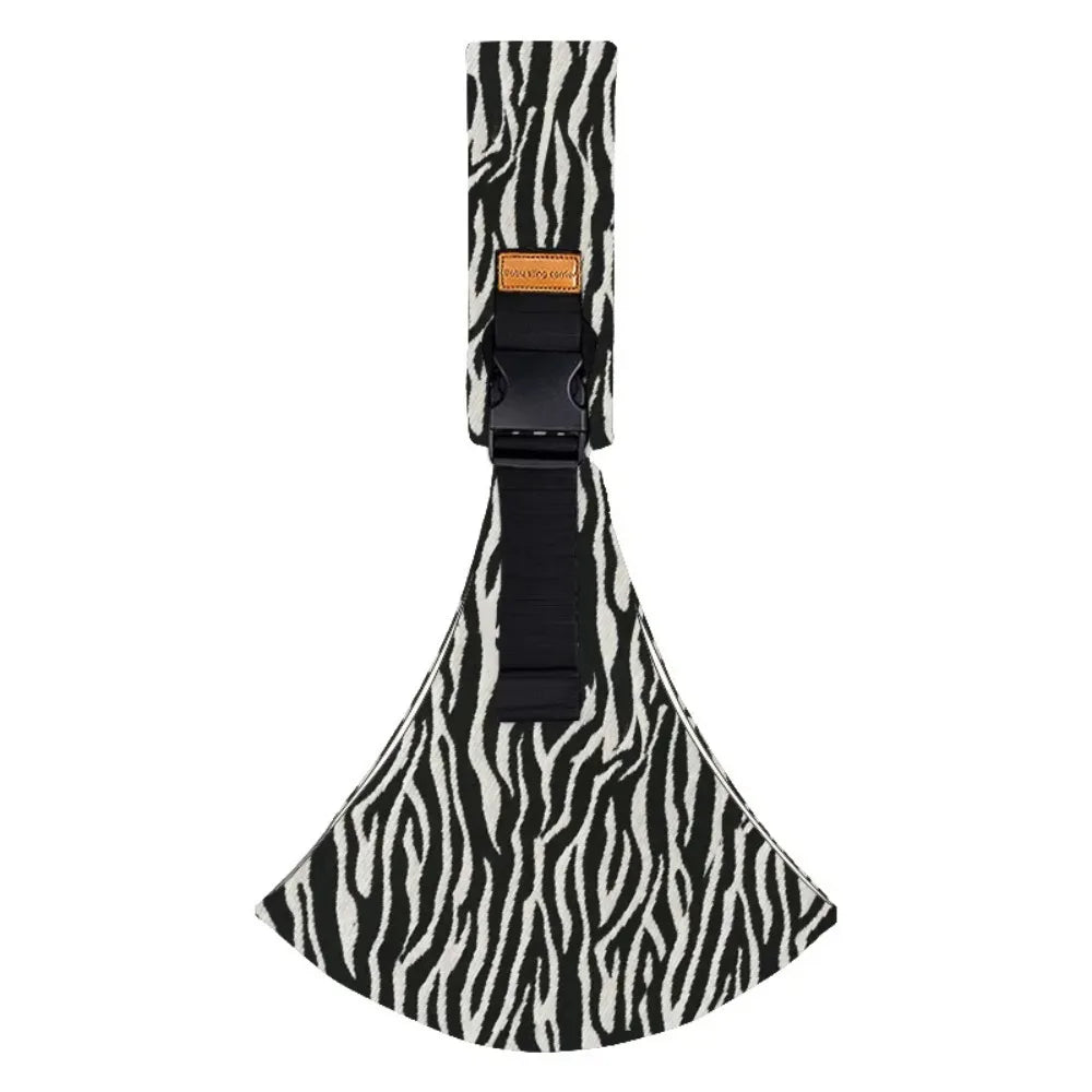 Adjustable cotton baby carrier with black and white zebra print, buckle, and brown logo tag.