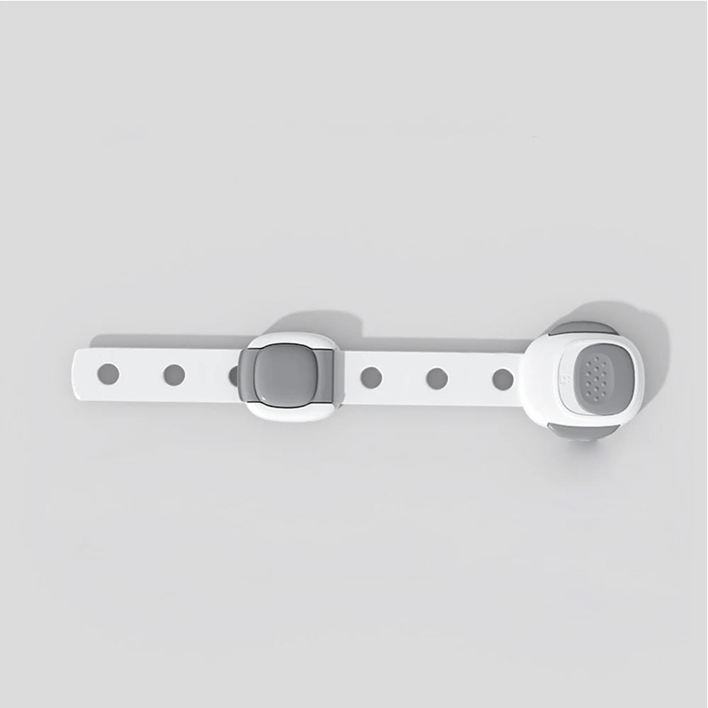 White and gray plastic toilet seat safety lock for toddlers and pets, with adjustable strap.