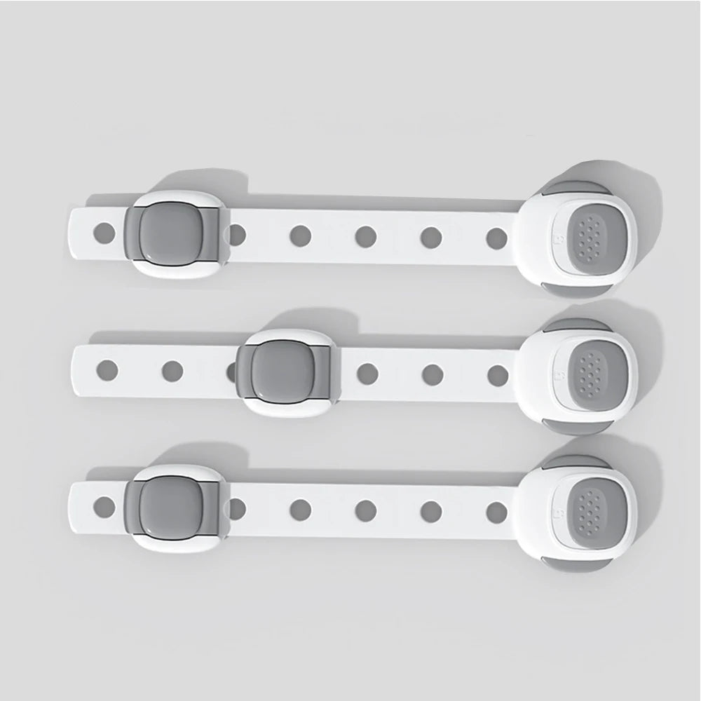 Three white plastic toilet safety locks with gray buttons, designed for toddlers and pets.