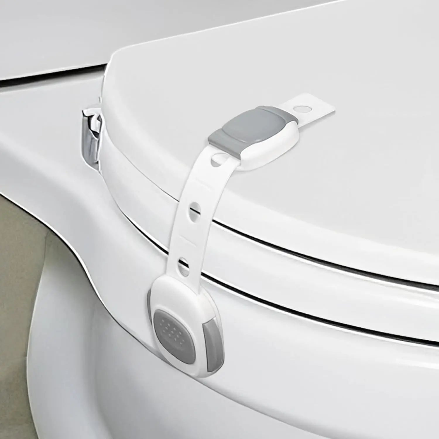 White plastic toilet seat lock with gray buttons for child and pet safety.