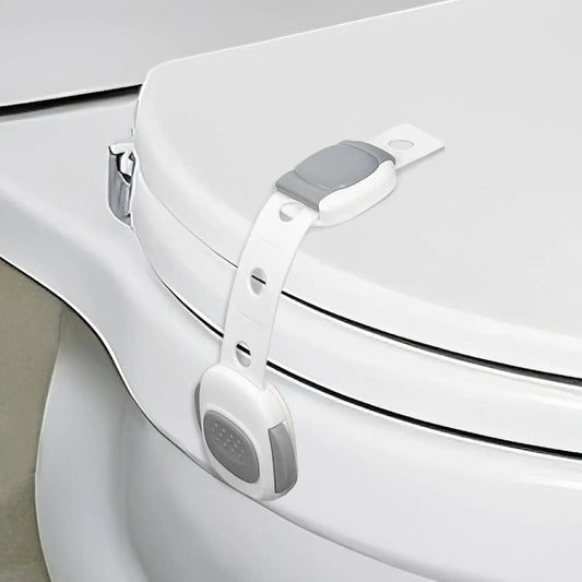 White plastic toilet seat lock with gray buttons for child and pet safety.