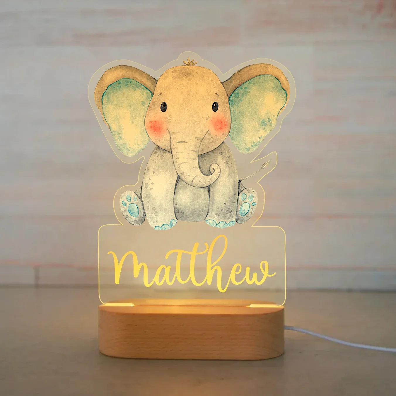 Personalized LED night light with a cute elephant design, "Matthew" engraved, and a natural wood base.