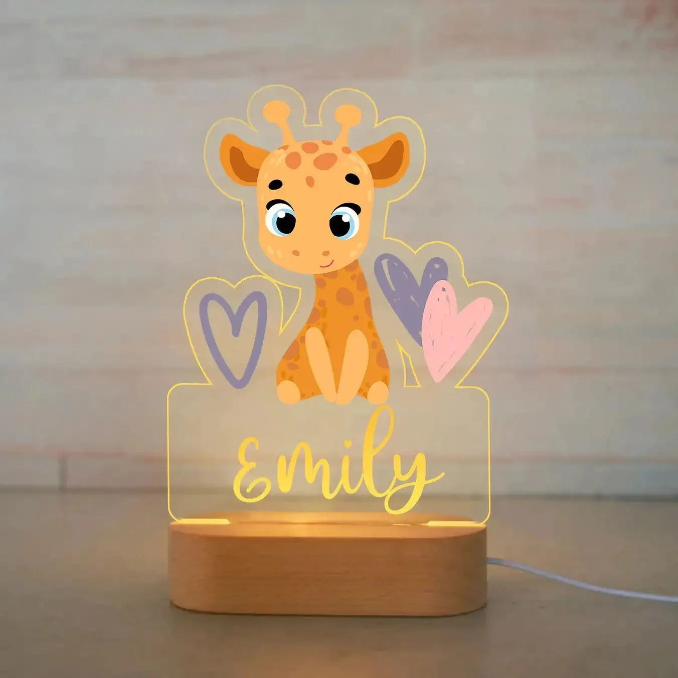 Personalized acrylic night light with a cute giraffe and hearts, on a wooden base, featuring the name "Emily".