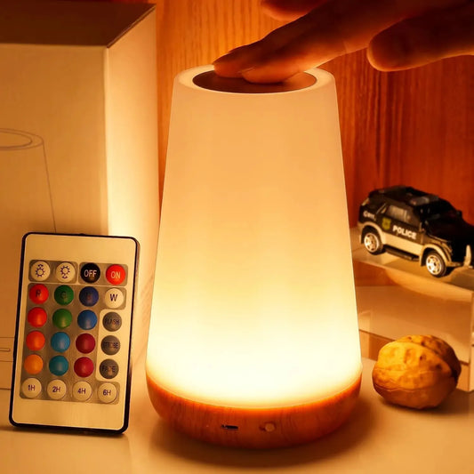Rechargeable smart RGB LED night light with remote, touch control, and wooden base, glowing softly.