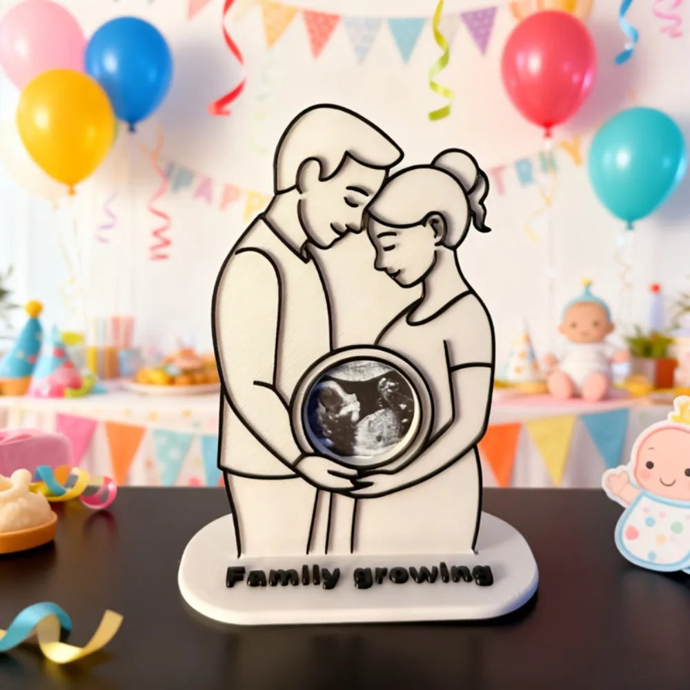 White plastic ultrasound photo frame with a couple embracing, holding a baby's sonogram.