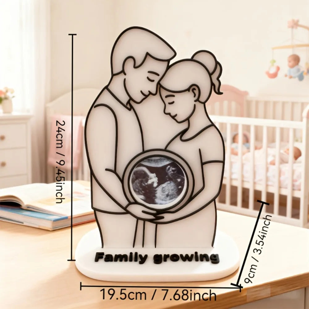 White plastic ultrasound photo frame with a couple silhouette, "Family growing" base, and dimensions.