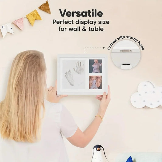 White classic baby handprint and footprint keepsake photo frame held by a woman, with two photo slots.