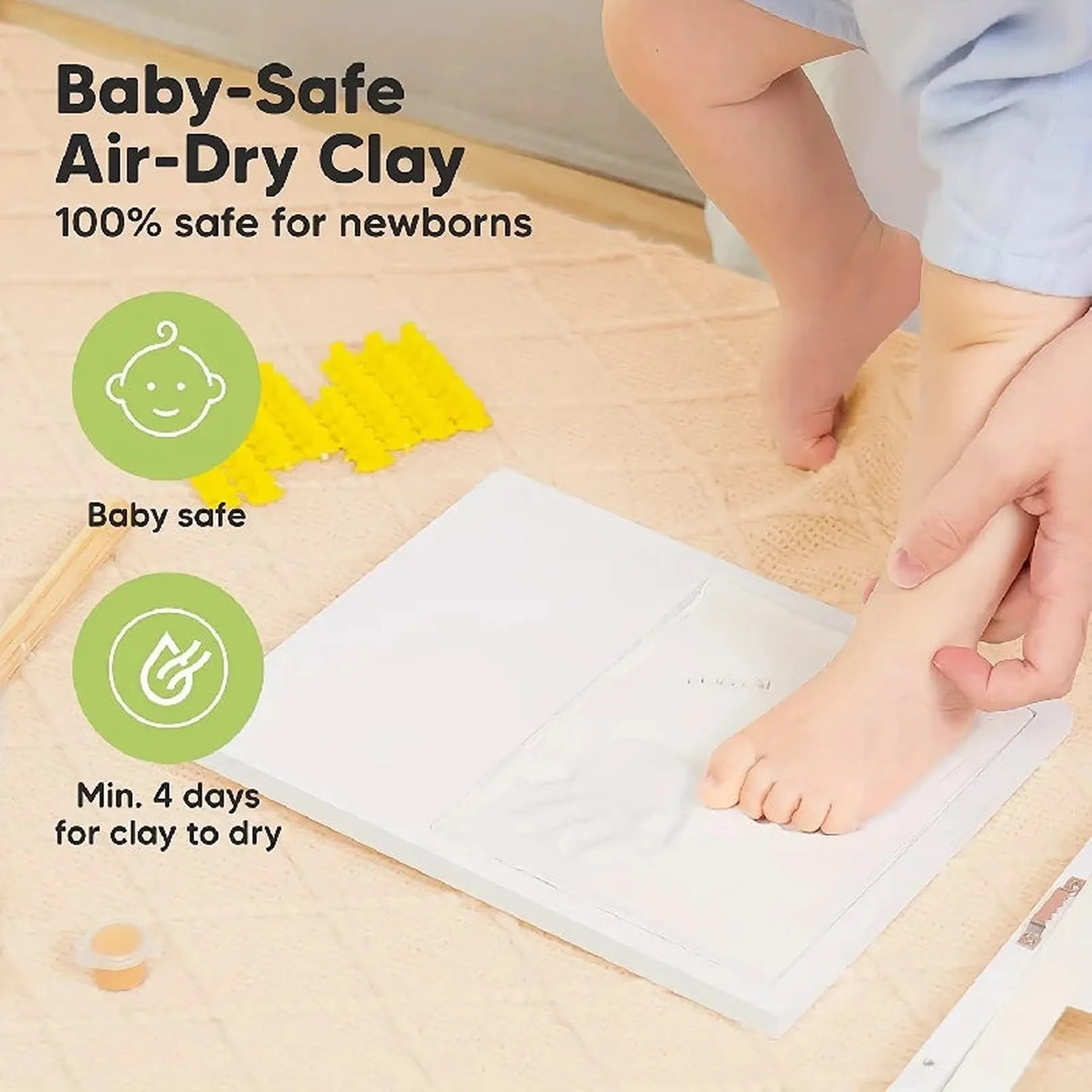 White baby handprint and footprint keepsake frame with air-dry clay, shown with a baby's foot.