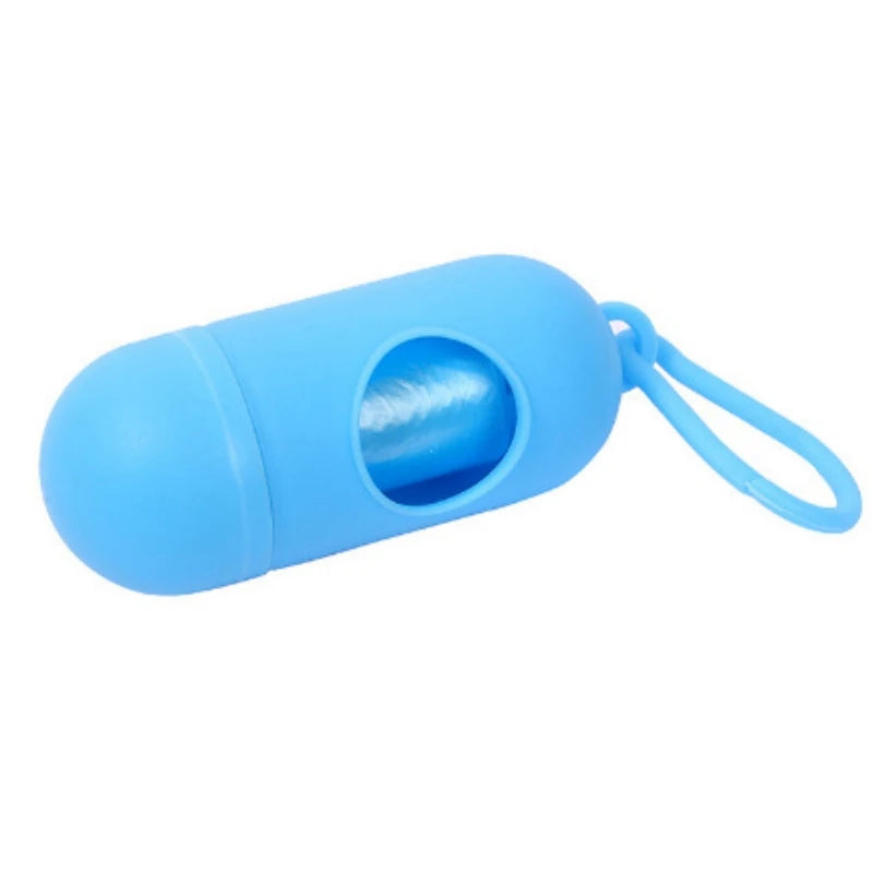 Light blue capsule-shaped portable waste bag dispenser for diapers, with a white bag roll visible.