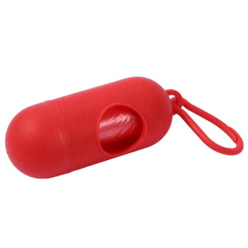 Red capsule-shaped portable waste bag dispenser with a loop for easy attachment.