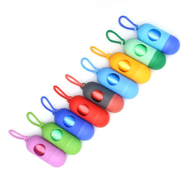 Colorful capsule-shaped portable waste bag dispensers with clips, ideal for diapers or pet waste.