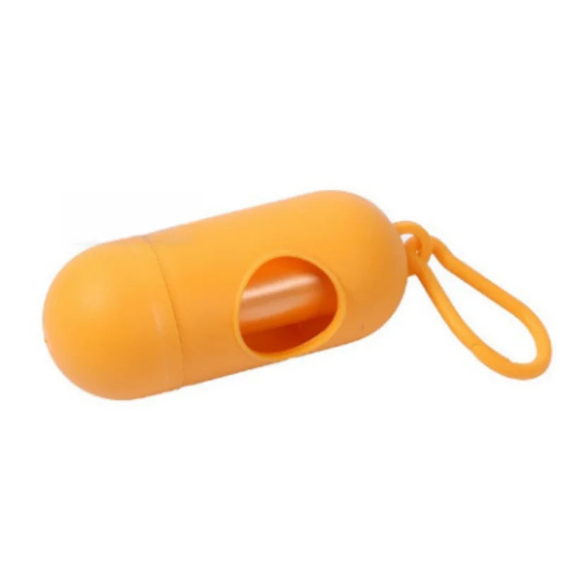 Orange capsule-shaped portable waste bag dispenser with a clip, ideal for diapers or pet waste.
