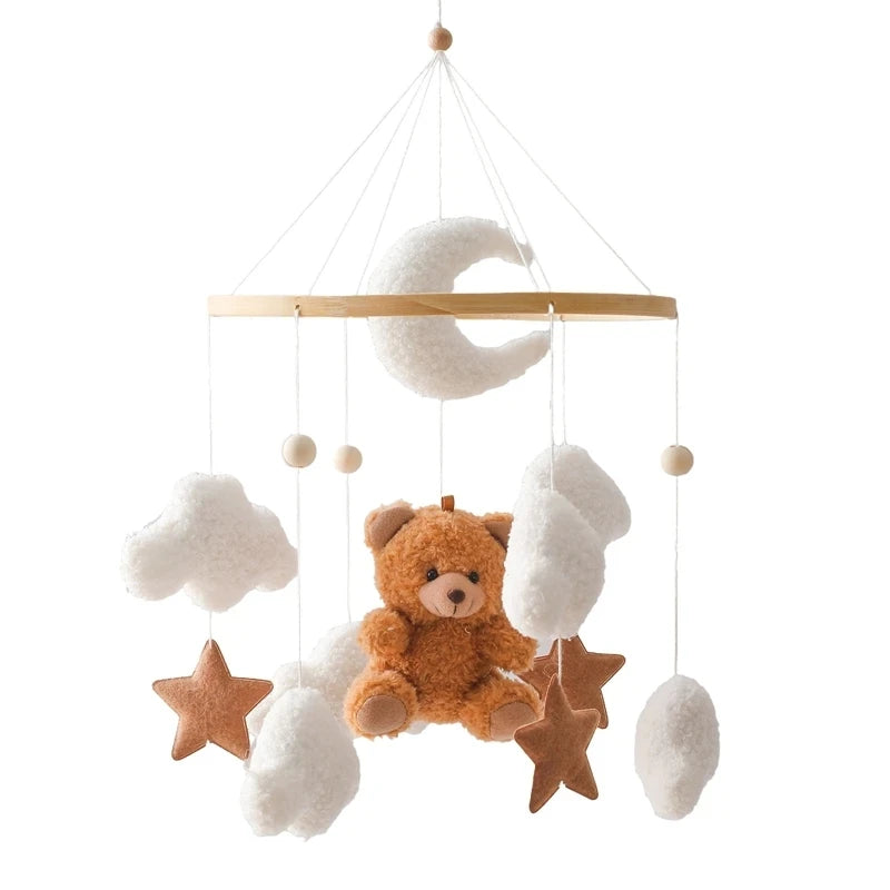 Wooden crib mobile with a brown teddy bear, white moon, clouds, and brown felt stars.
