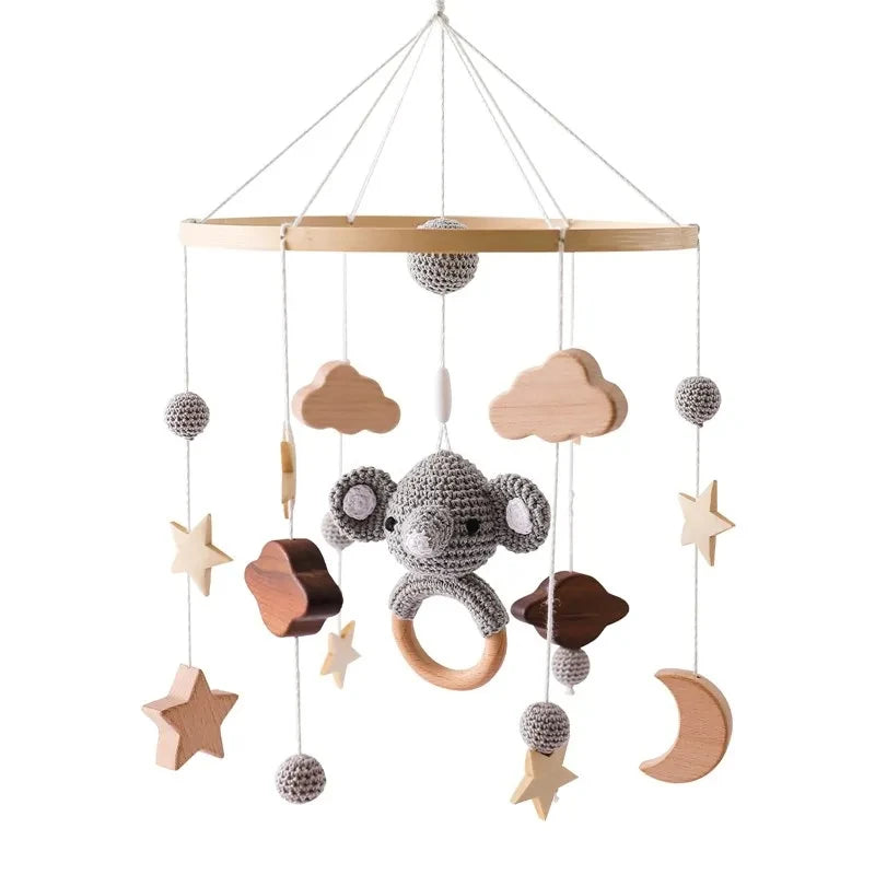 Nordic wooden baby crib mobile with crochet elephant, clouds, stars, and moon.