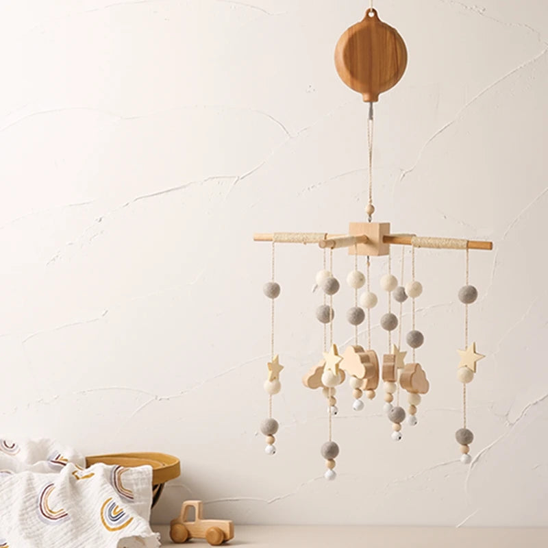 Nordic wooden musical crib mobile with felt balls, stars, and clouds for baby nursery.