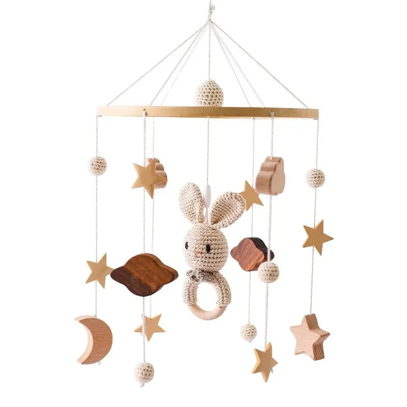 Nordic wooden musical crib mobile with a crocheted bunny, stars, moons, and clouds.